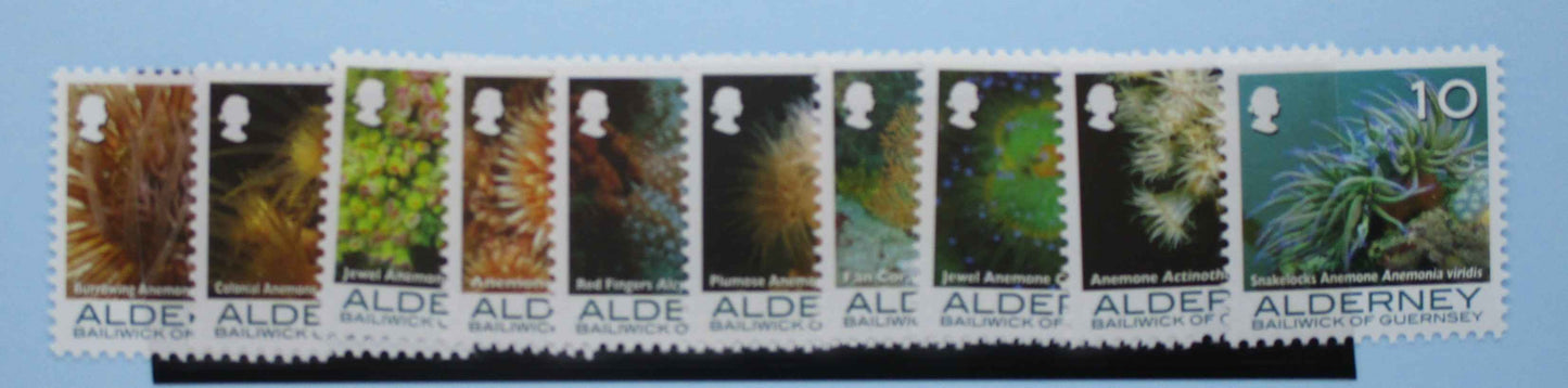 Collection of stamps with a variety of natural scenes and a portrait on a blue background
