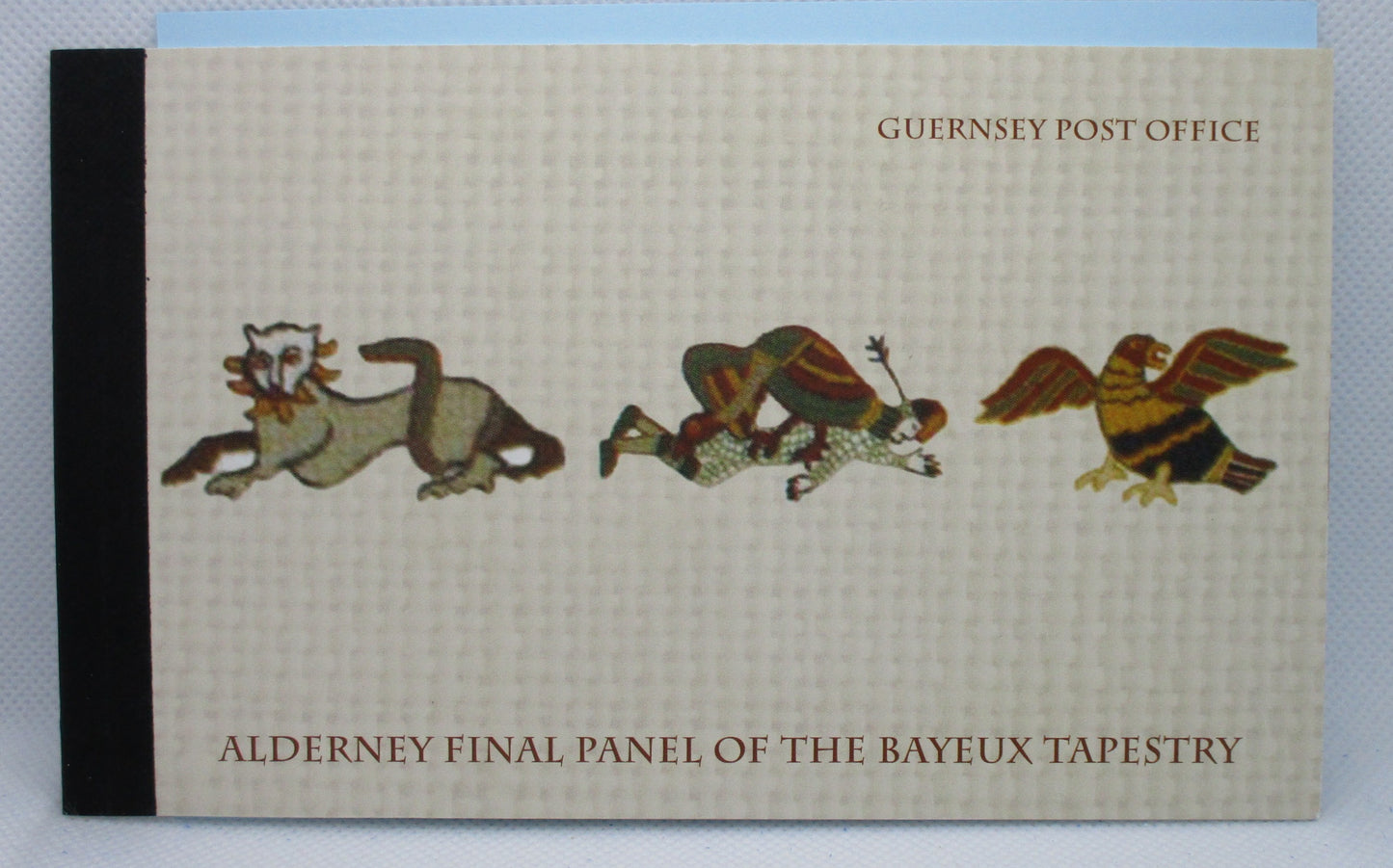 Booklet with illustrations of animals and text 'Guernsey Post Office Alderney Final Panel of the Bayeux Tapestry' on a plain background.