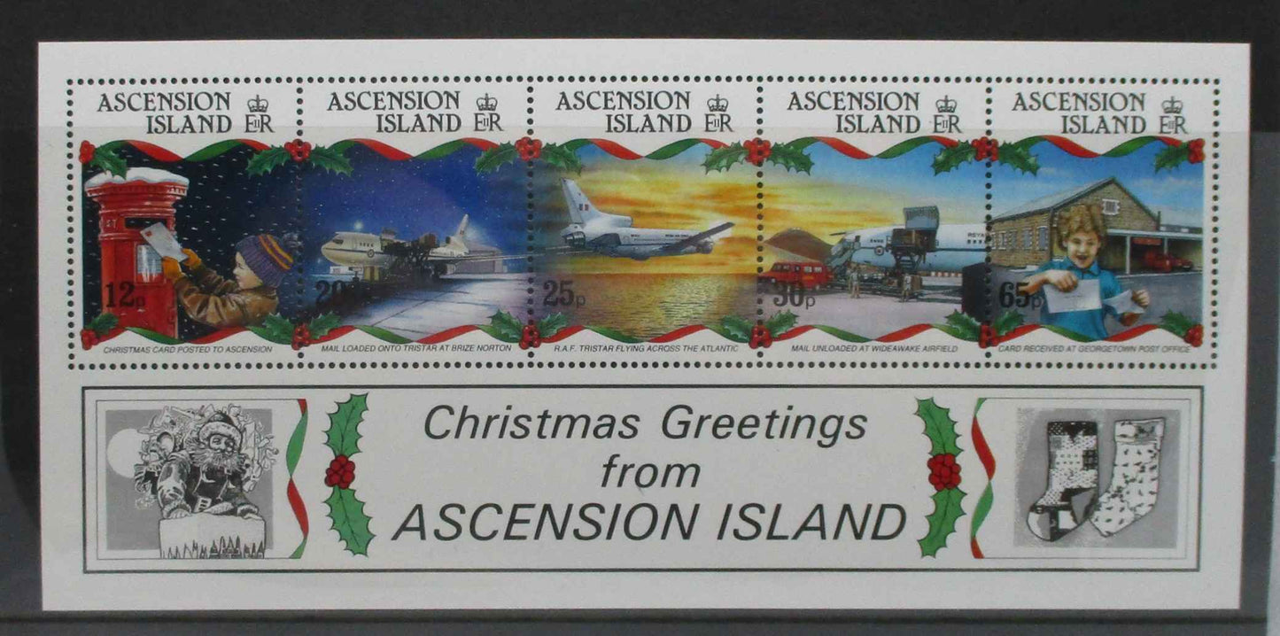 Ascension Island Christmas postage stamp souvenir sheet with five colorful stamps depicting holiday scenes and a white border with 'Christmas Greetings from ASCENSION ISLAND' text and small black-and-white illustrations.