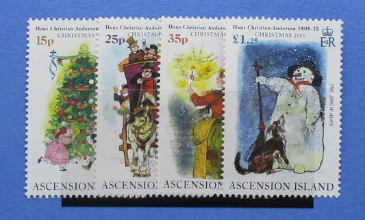 Four Christmas postage stamps from Ascension Island featuring Hans Christian Andersen illustrations, displayed on a blue background with a black support bar.