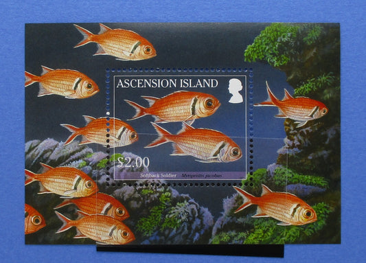 Ascension Island postage stamp sheet featuring multiple orange-red fish swimming over an underwater coral reef scene, with the text 'ASCENSION ISLAND' and a $2.00 denomination on a blue background.