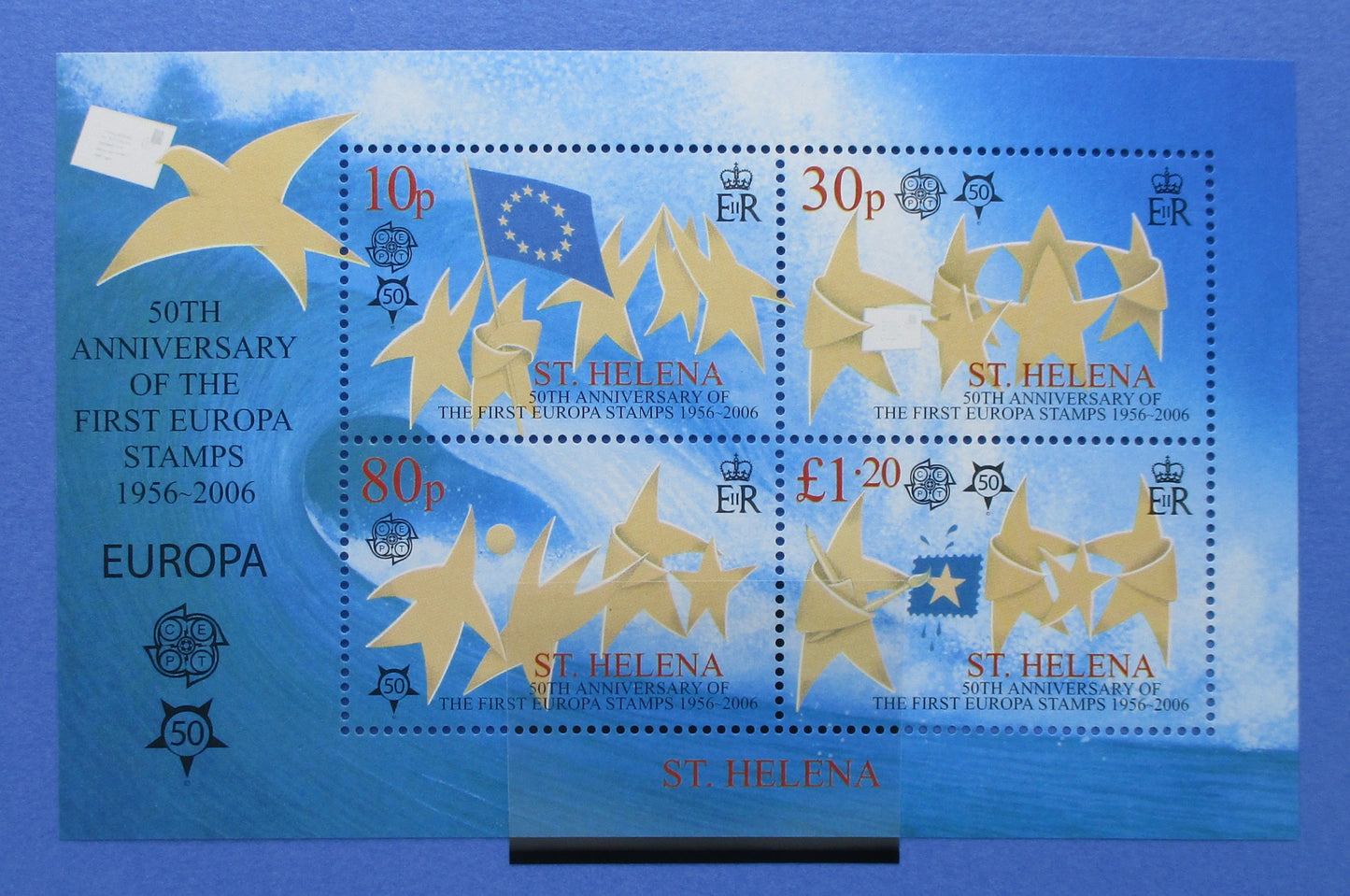 A blue and gold 50th Anniversary of the First Europa Stamps 1956-2006 souvenir sheet featuring four St. Helena postage stamps with yellow stars and blue EU flag motifs.