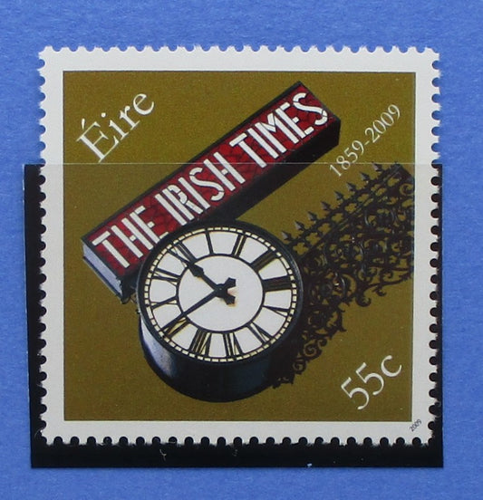 Stylized postage stamp with 'The Irish Times' logo and clock design on a blue background