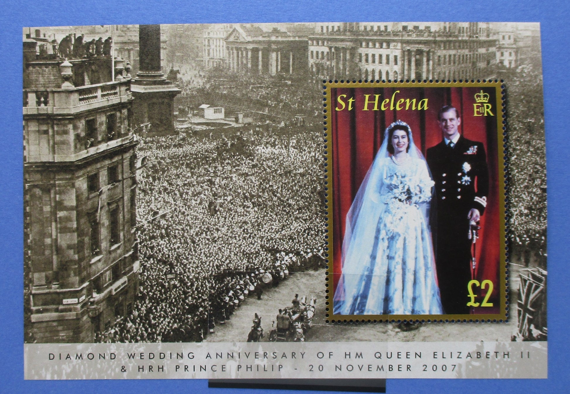 A commemorative St Helena postage stamp sheet celebrating the Diamond Wedding Anniversary of Queen Elizabeth II and Prince Philip, featuring a black-and-white historical crowd scene on the left and a small rectangular stamp on the right showing the couple in wedding attire with 'St Helena' and '£2' text.